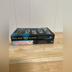 Two Paper Back Books -You Are Not Alone & And There He Kept Her Books
